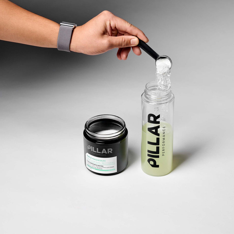 The PILLAR Performance Triple Magnesium Professional Recovery Powder in the Lemon & Lime flavour been added to water. 