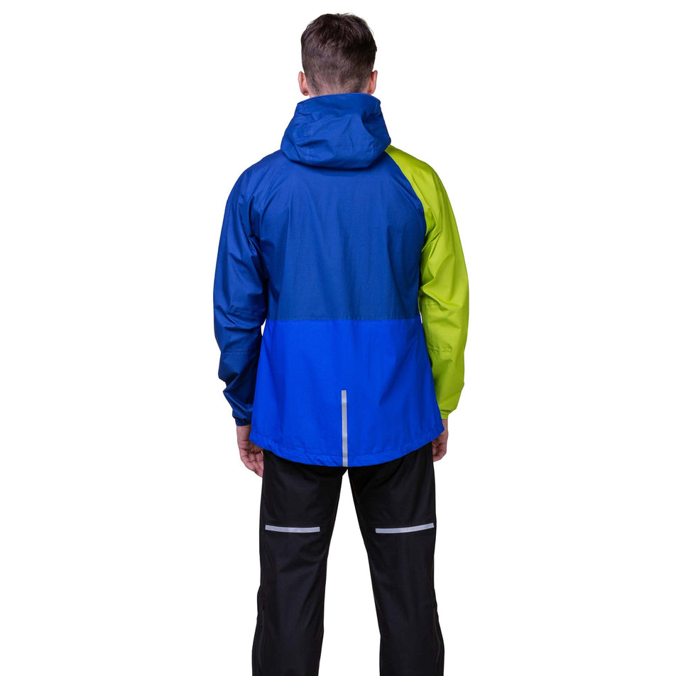 Back view of a model wearing the Ronhill Men's Tech Fortify Jacket in the Ocean/Citrus colourway. Model is also wearing Ronhill trousers. (8160892911778)