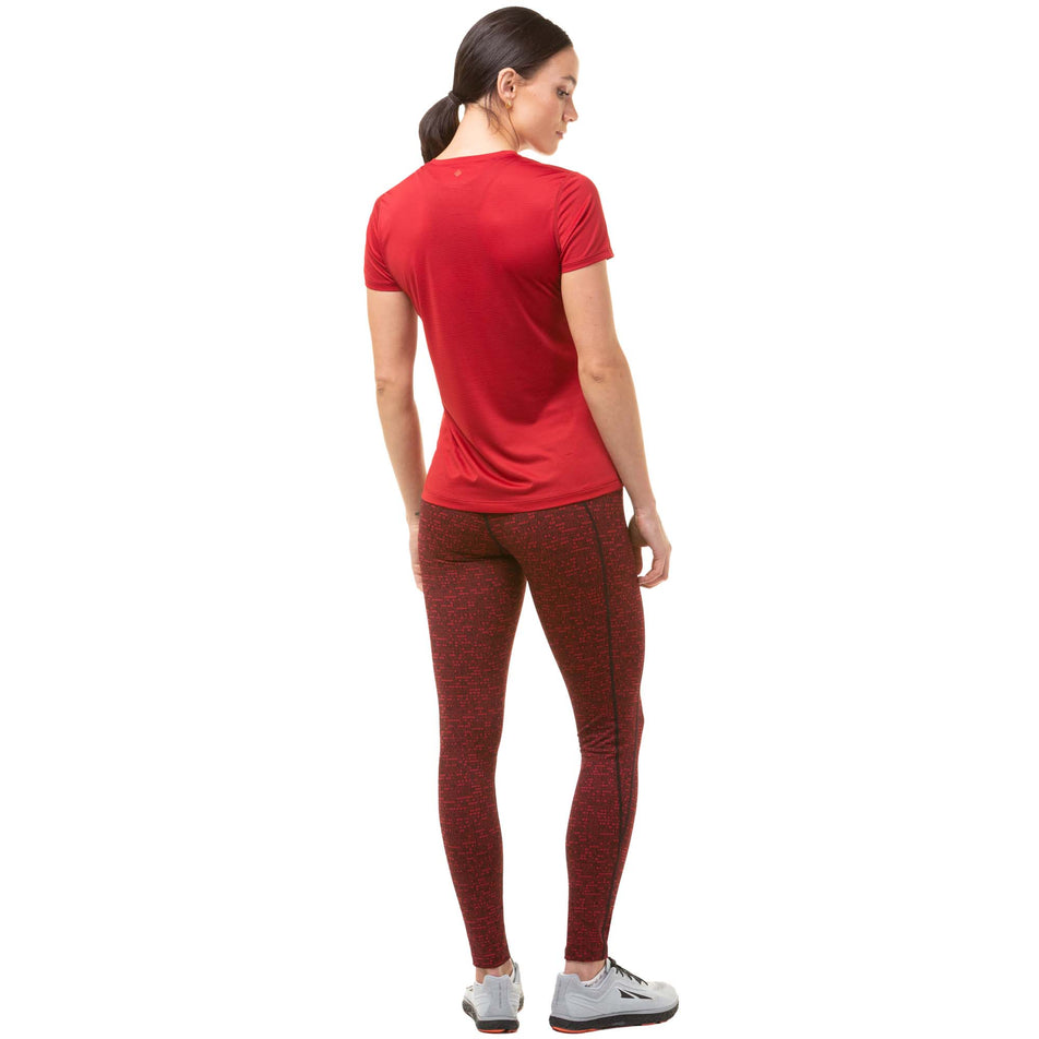 Back view of a model wearing a Ronhill Women's Tech S/S Tee in the Jam/Flame colourway. Model is also wearing Ronhill running leggings and Altra running shoes. (8047387181218)