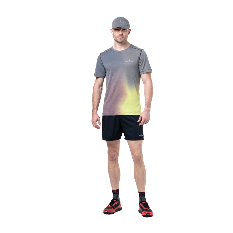 Front view of a model wearing the Ronhill Men's Tech Golden Hour Tee in the Acid Merge colourway. (8742874513570)