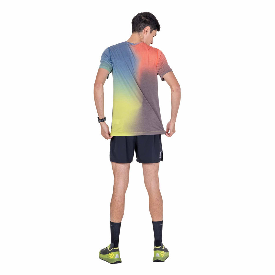 Back view of a model wearing the Ronhill Men's Tech Golden Hour S/S Tee in the Ronhill Red Merge colourway.