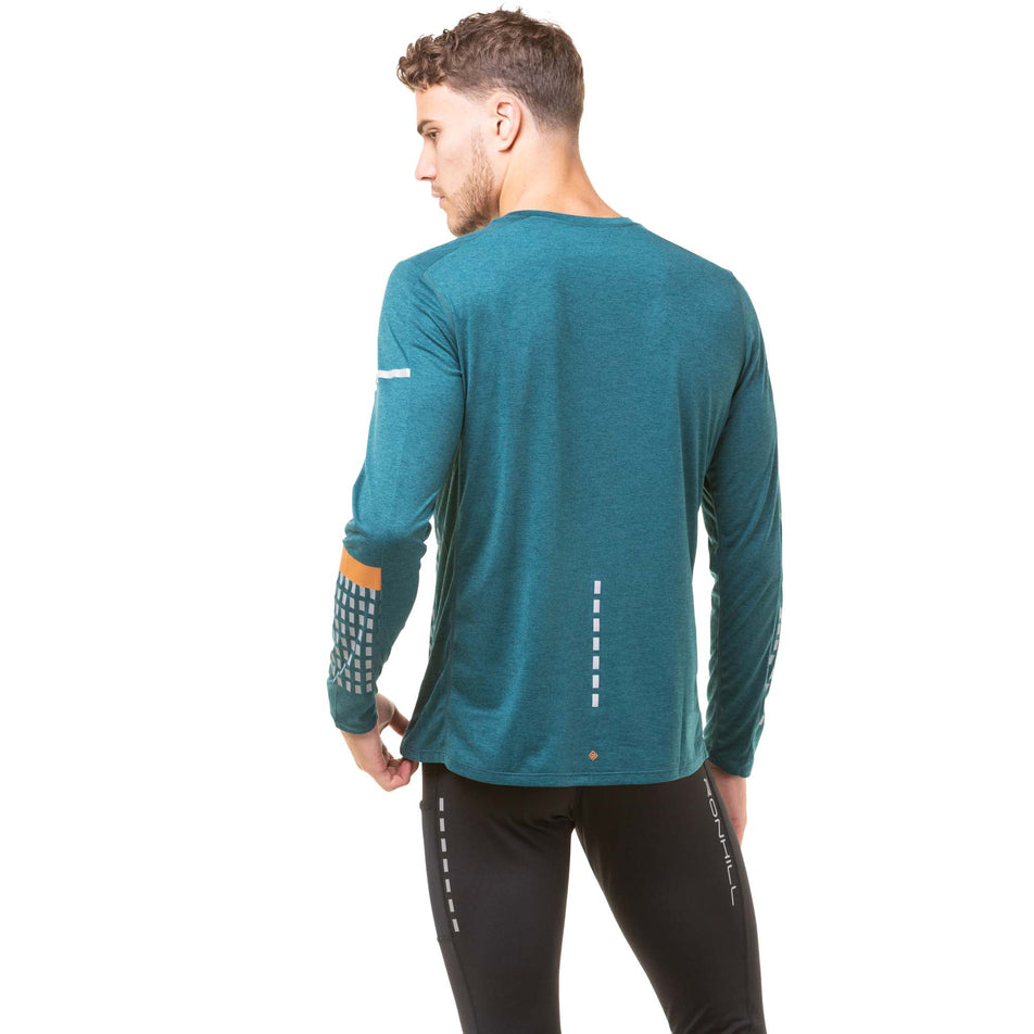 Back view of a model wearing a Ronhill Men's Tech Afterhours L/S Tee in the Deep Lagoon/Copper Reflect colourway. Model also wearing Ronhill running tights. (8048083337378)