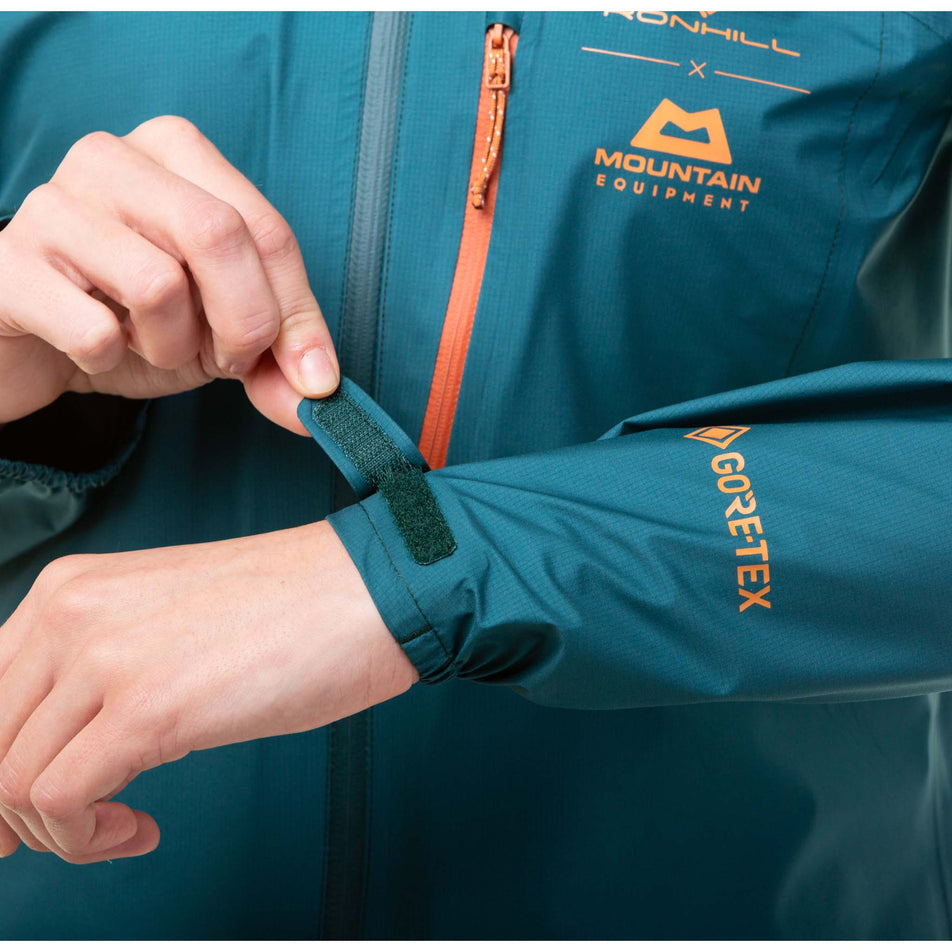 A model demonstrating that the sleeves on a Ronhill Women's Gore-Tex Mercurial Jacket can be adjusted with a Velcro tab (8059839119522)