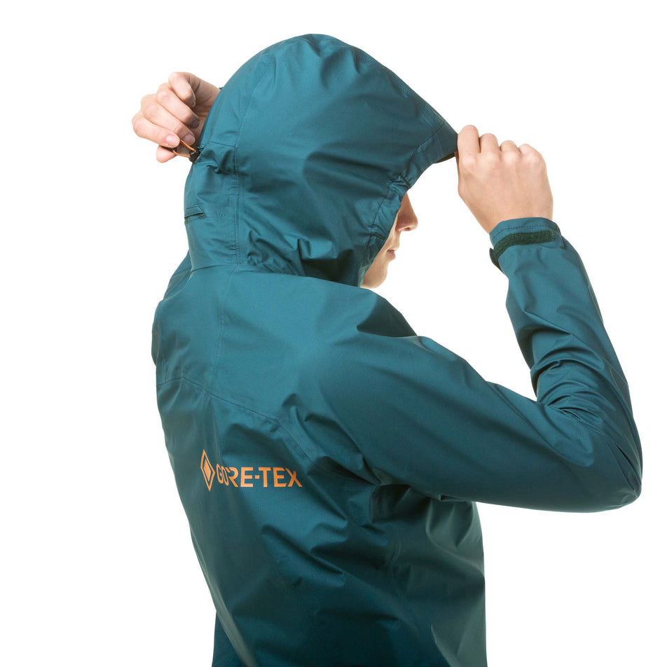 A model demonstrating that the hood on a Ronhill Women's Gore-Tex Mercurial Jacket can be adjusted (8059839119522)