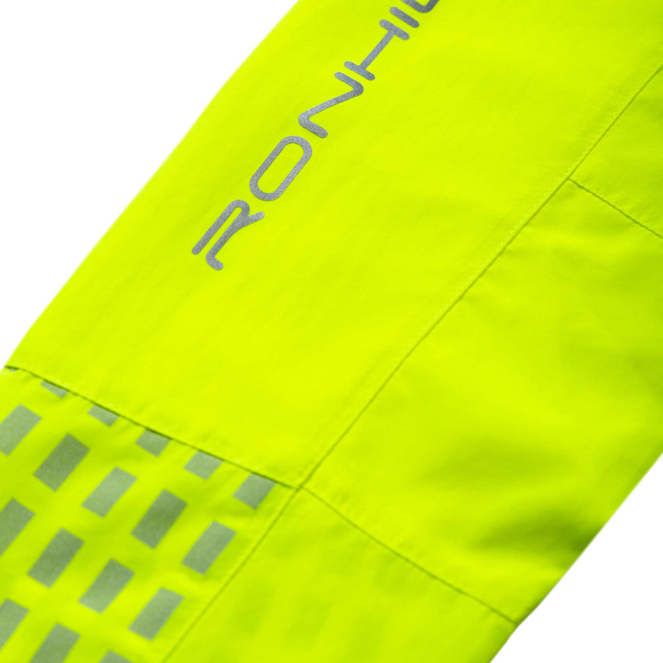 Close-up view of some of the reflective detail on the sleeve of a Ronhill Women's Tech Afterhours Jacket in the Fluo Yellow/Deep Lagoon/Reflect colourway. (8019130286242)