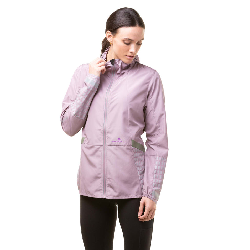 Front view of a model wearing a Ronhill Women's Tech Afterhours Jacket in the Stardust/Thistle/Reflect colourway. (8019199557794)