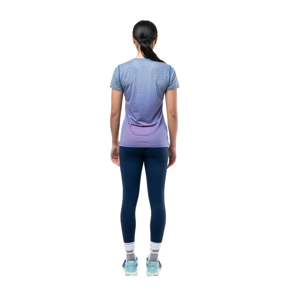 Back view of a model wearing the Ronhill Women's Tech Golden Hour S/S Tee in the Classic Blue Refraction colourway.
