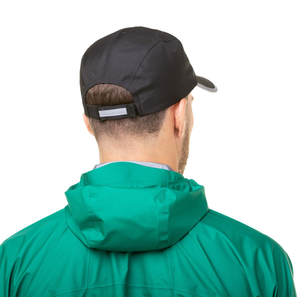Back view of a model wearing a Ronhill Unisex Fortify Cap in the All Black colourway (8033746714786)