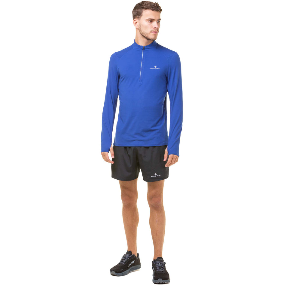 Front view of a model wearing a Ronhill Men's Core Thermal 1/2 Zip in the Dark Cobalt/Bright White colourway. Model is also wearing Ronhill running shorts and Altra running shoes. (8048138715298)