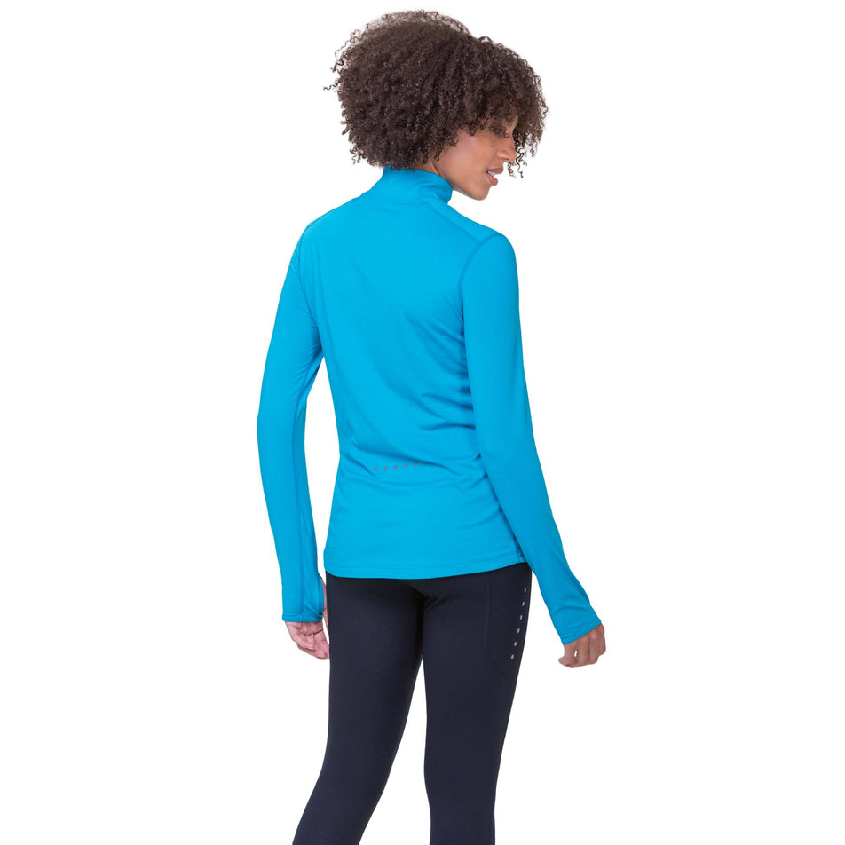 Back view of a model wearing a Ronhill Women's Core Thermal 1/2 Zip in the Azure/Bright White colourway. Model is also wearing Ronhill leggings. (8159242813602)