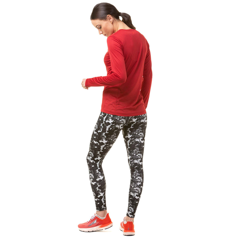 Back view of a model wearing a pair of Ronhill Women's Tech Tights in the Mono Fern Frost colourway. Model is also wearing a Ronhill running top and Altra running shoes. (8047451832482)