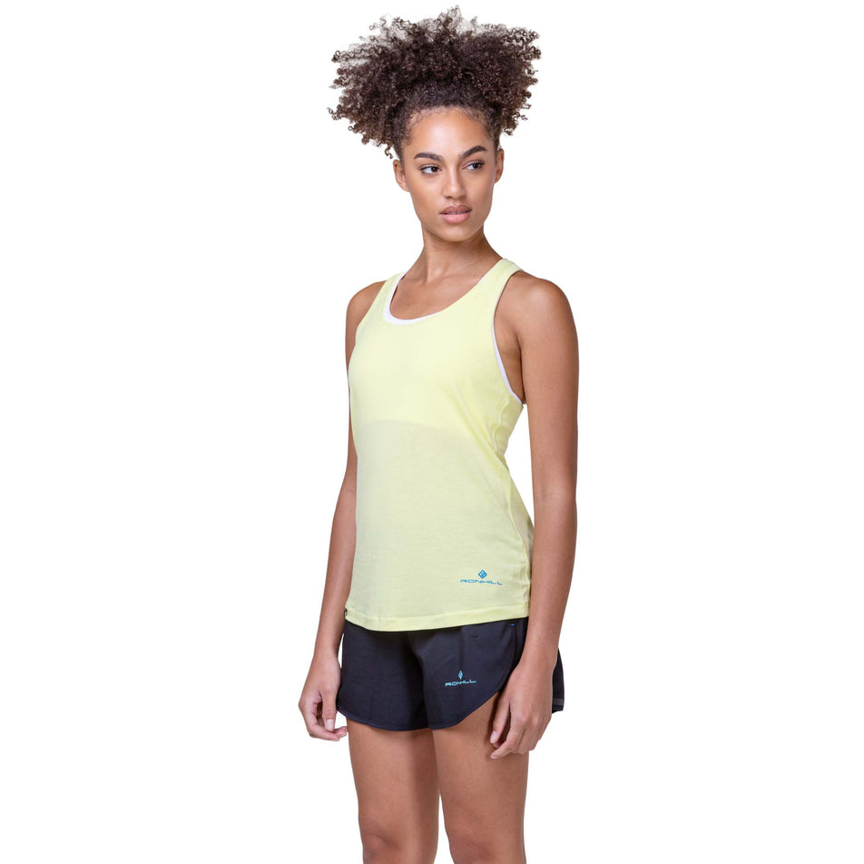 Front view of a model wearing a Ronhill Women's Tech Tencel Vest in the Zest Marl/Electric Blue colourway. Model is also wearing Ronhill shorts. (8159380537506)