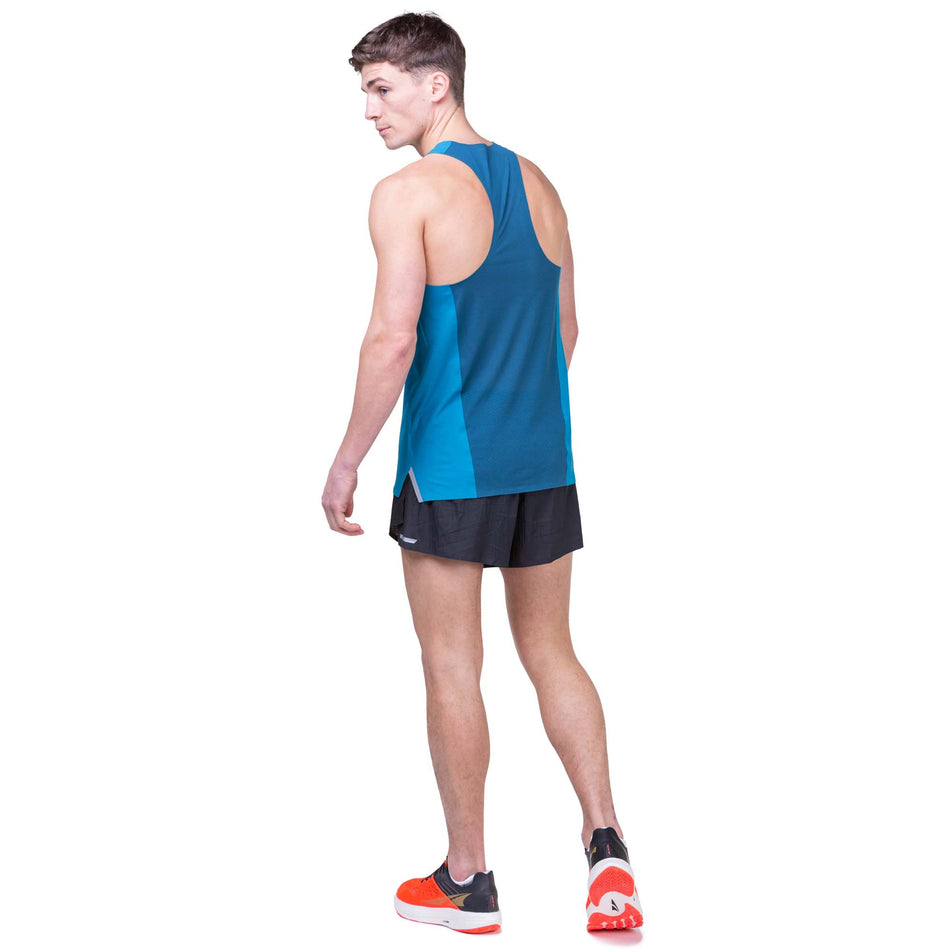Back view of a model wearing the Ronhill Men's Tech Race Vest in the Petrol/Legion Blue colourway. Model is also wearing Ronhill running shorts and Altra running shoes. (8160871448738)