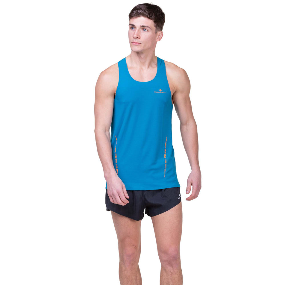 Front view of a model wearing the Ronhill Men's Tech Race Vest in the Petrol/Legion Blue colourway. Model is also wearing Ronhill running shorts. (8160871448738)