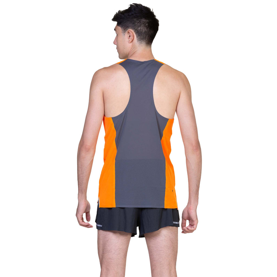 Back view of a model wearing the Ronhill Men's Tech Race Vest in the Tangelo/Artemis colourway. (8563607109794)