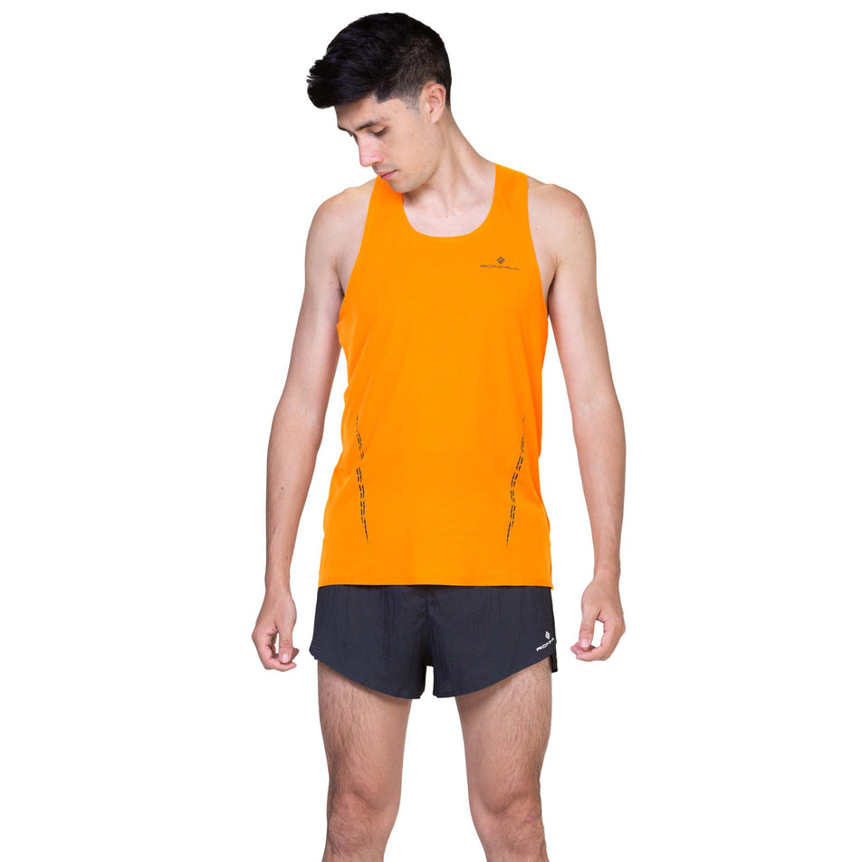 Front view of a model wearing the Ronhill Men's Tech Race Vest in the Tangelo/Artemis colourway. (8563607109794)