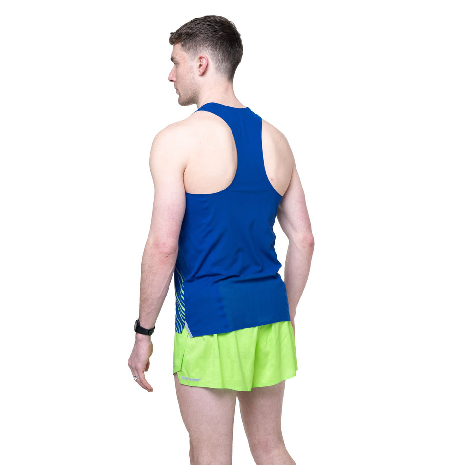 Back view of a model wearing the Ronhill Men's Tech Race Vest in the Dark Cobalt/Fluo Green colourway.