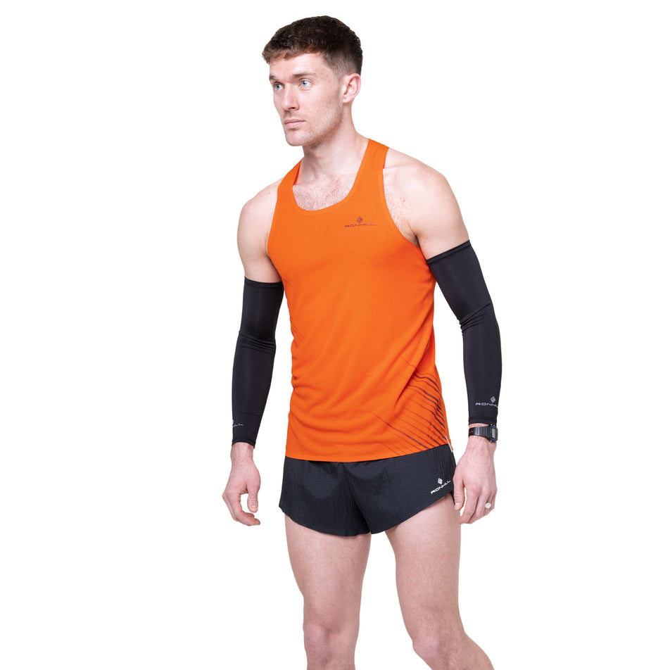 Front view of a model wearing the Ronhill Men's Tech Race Vest in the Ronhill Red/Black colourway.