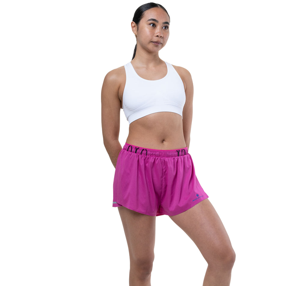 Front view of a model wearing the Ronhill Women's Tech Race Short in the Exuberance/Classic Blue colourway.