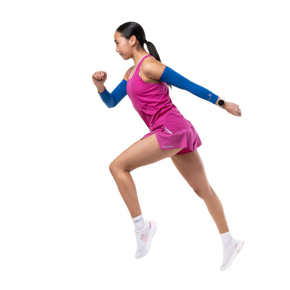 Side view of a model wearing the Ronhill Women's Tech Race Vest in the Exuberance/Classic Blue colourway.