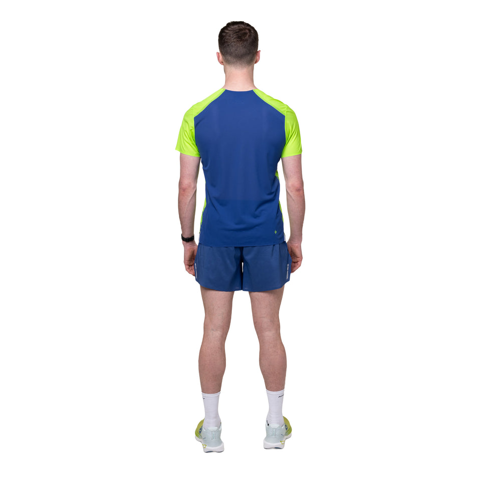 Back view of a model wearing the Ronhill Men's Tech Race S/S Tee in the Fluo Green/Dark Cobalt colourway.