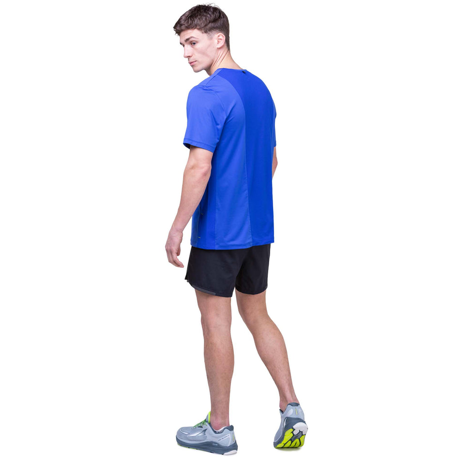 Back view of a model wearing the Ronhill Men's Tech 1/2 Zip S/S Tee in the Azurite/Citrus colourway. Model is also wearing Ronhill shorts and Altra running shoes. (8160879640738)