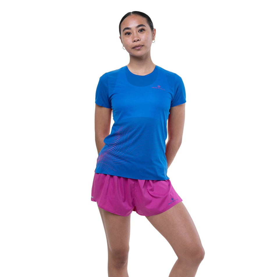 Front view of a model wearing the Ronhill Women's Tech Race S/S Tee in the Classic Blue/Exuberance colourway.