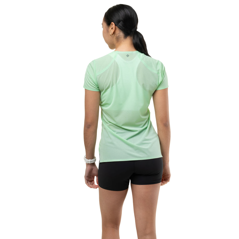 Back view of a model wearing the Ronhill Women's Tech Race S/S Tee in the Seafoam/Laurel colourway.