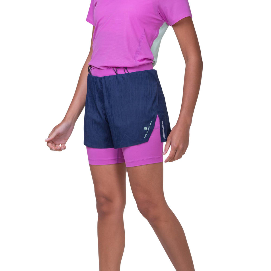 Front view of a model wearing the Ronhill Women's Tech Race Twin Short in the Dark Navy/Fuchsia colourway. Model is also wearing a Ronhill running top. (8159320768674)