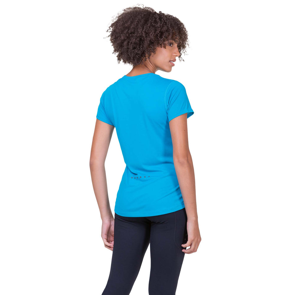 Back view of a model wearing a Ronhill Women's Core S/S Tee in the Azure/Bright White colourway. Model is also wearing Ronhill leggings. (8159237177506)