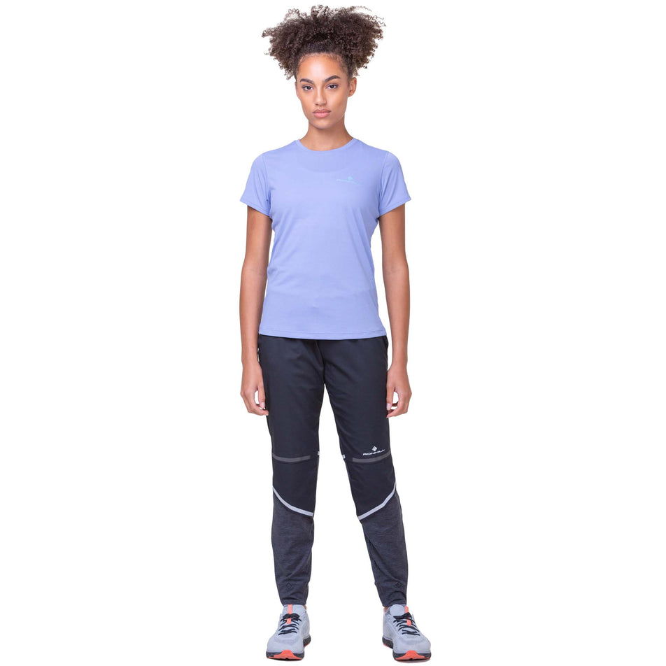 Front view of a model wearing a Ronhill Women's Core S/S Tee in the Periwinkle/Aquamint colourway. Model is also wearing Ronhill running trousers and Altra running shoes. (8159241437346)