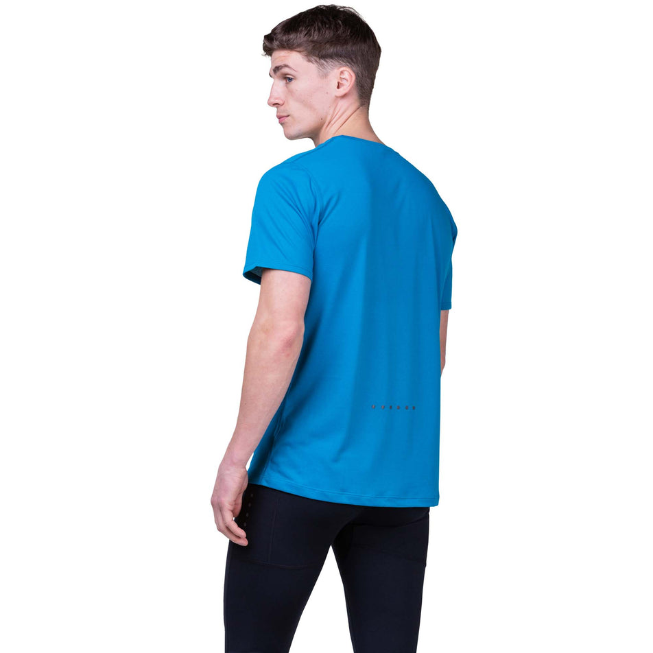 Back view of a model wearing a Ronhill Men's Core S/S Tee in the Petrol/Fluo Orange colourway. Model is also wearing Ronhill tights. (8159272698018)