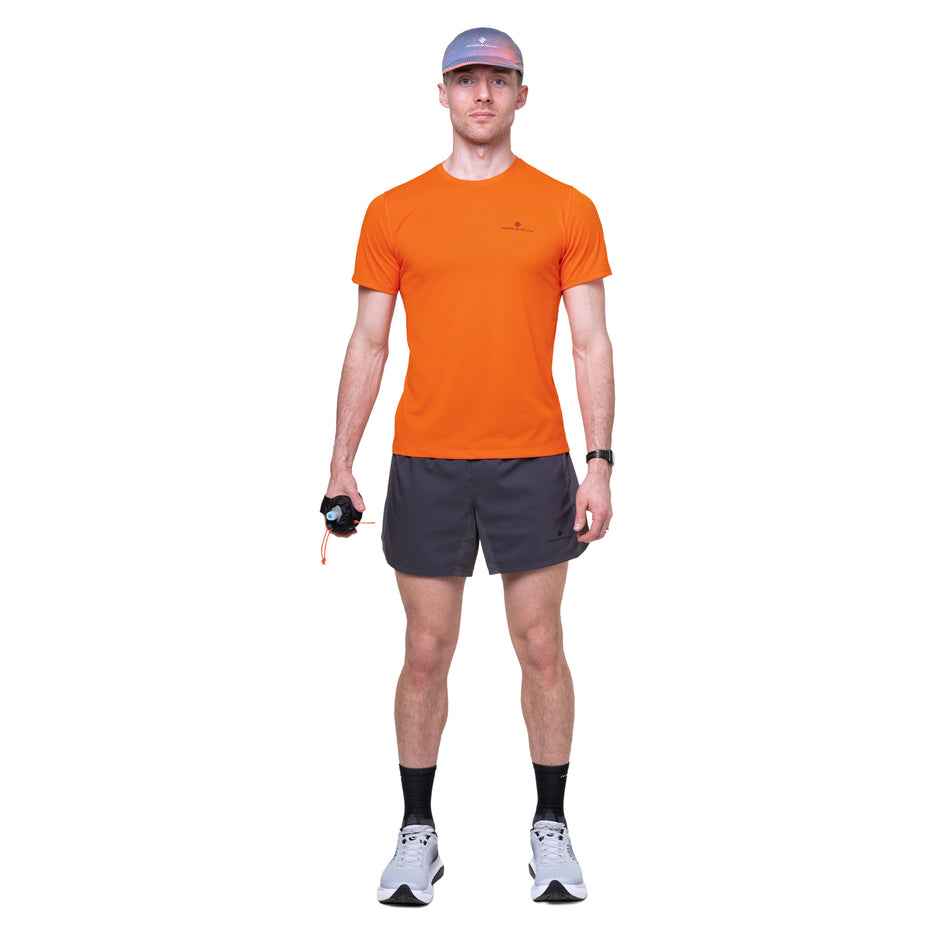 Front view of a model wearing the Ronhill Men's Core S/S Tee in the Ronhill Red/Black colourway.