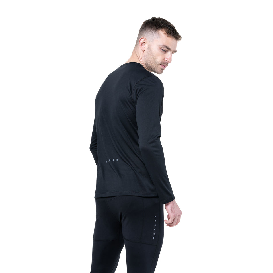 Back view of a model wearing the Ronhill Men's Core L/S Tee in the Black/Bright White colourway. (8748682608802)