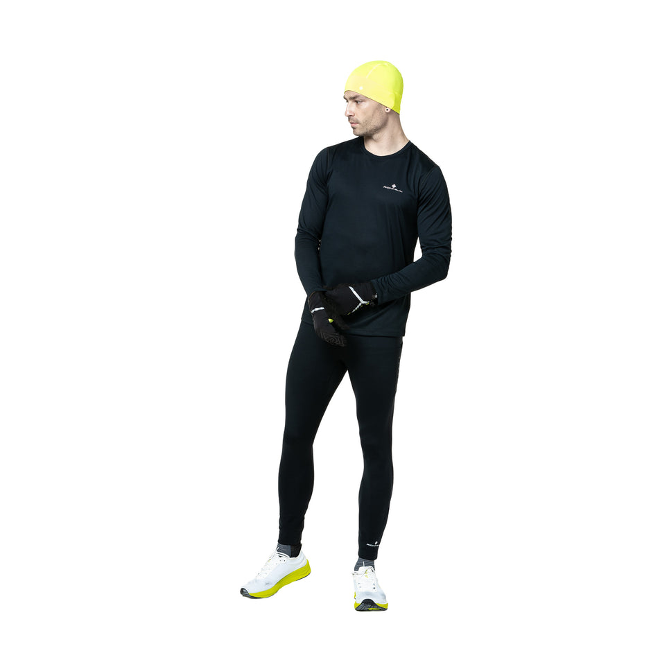 Front view of a model wearing the Ronhill Men's Core L/S Tee in the Black/Bright White colourway. (8748682608802)