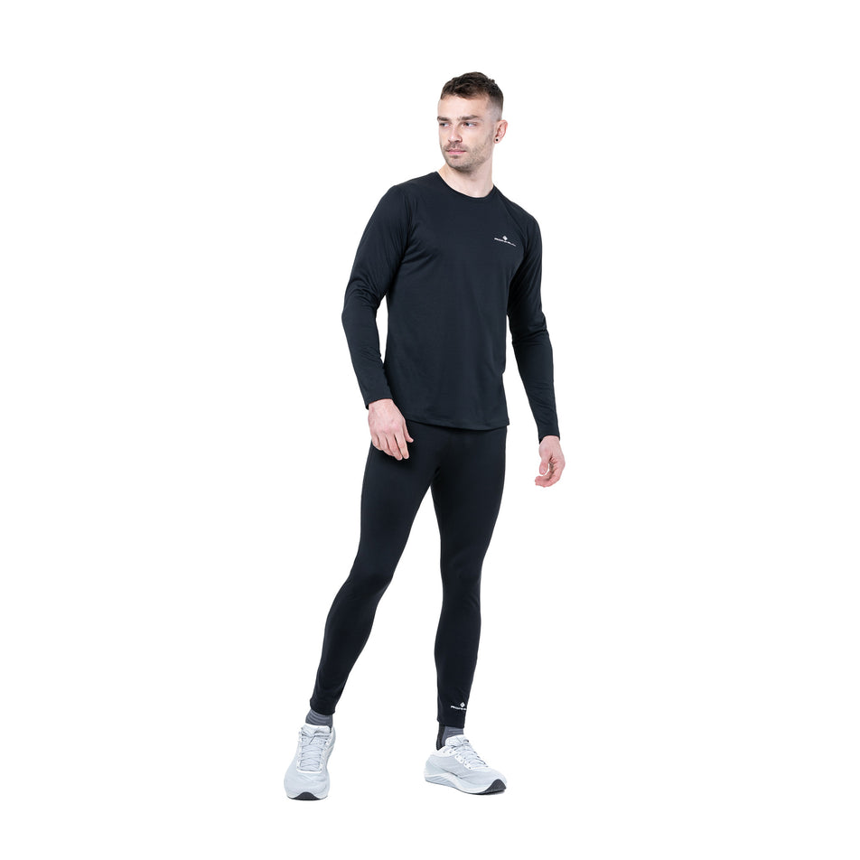 Front view of a model wearing the Ronhill Men's Core L/S Tee in the Black/Bright White colourway. (8748682608802)