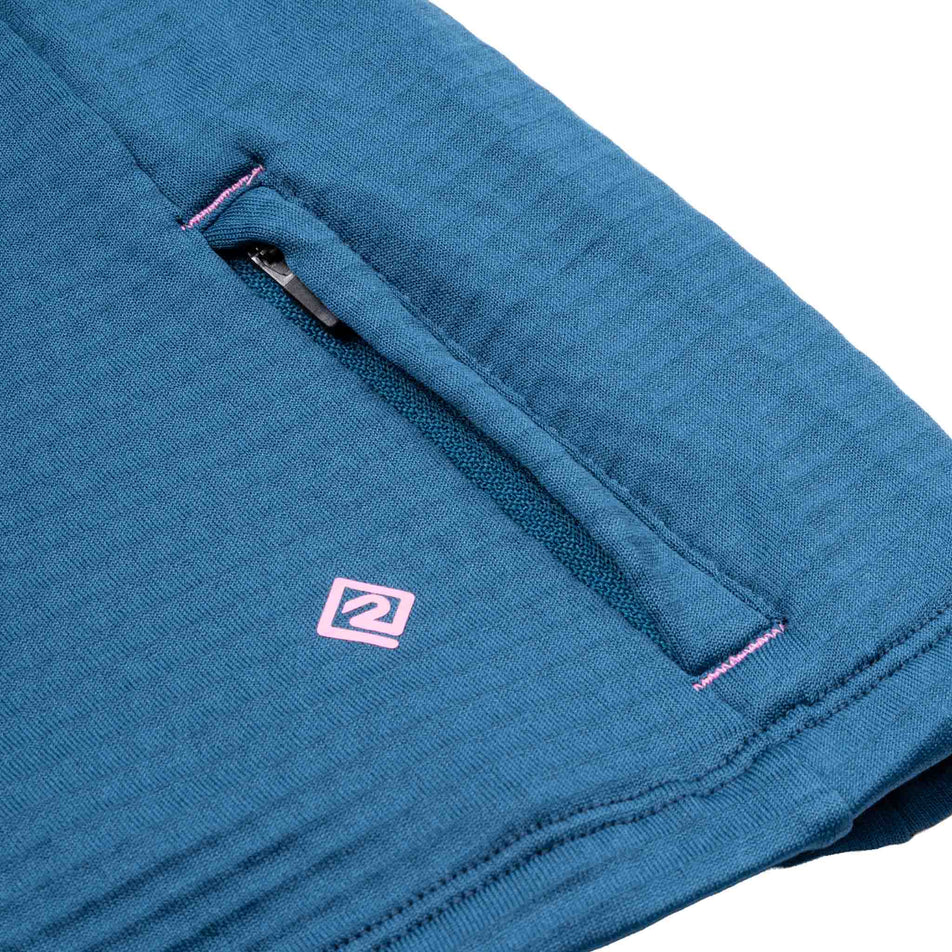 Close-up view of the zip pocket on the Ronhill Women's Tech Winter 1/2 Zip in the Legion Blue/Orchid colourway.