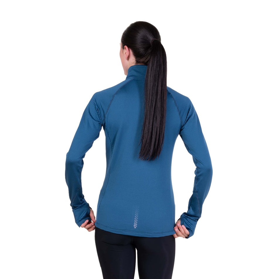 Back view of a model wearing the Ronhill Women's Tech Winter 1/2 Zip in the Legion Blue/Orchid colourway.