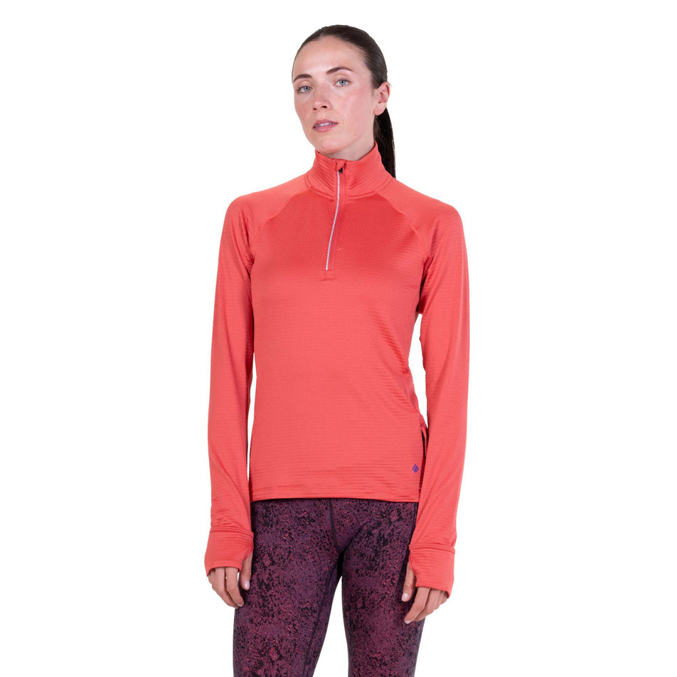 Front view of a model wearing the Ronhill Women's Tech Winter 1/2 Zip in the Sumac/Blue Violet colourway.