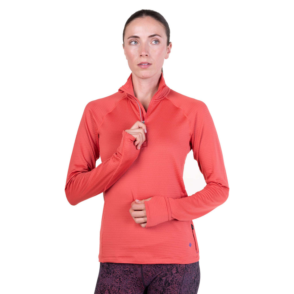 Front view of a model wearing the Ronhill Women's Tech Winter 1/2 Zip in the Sumac/Blue Violet colourway.