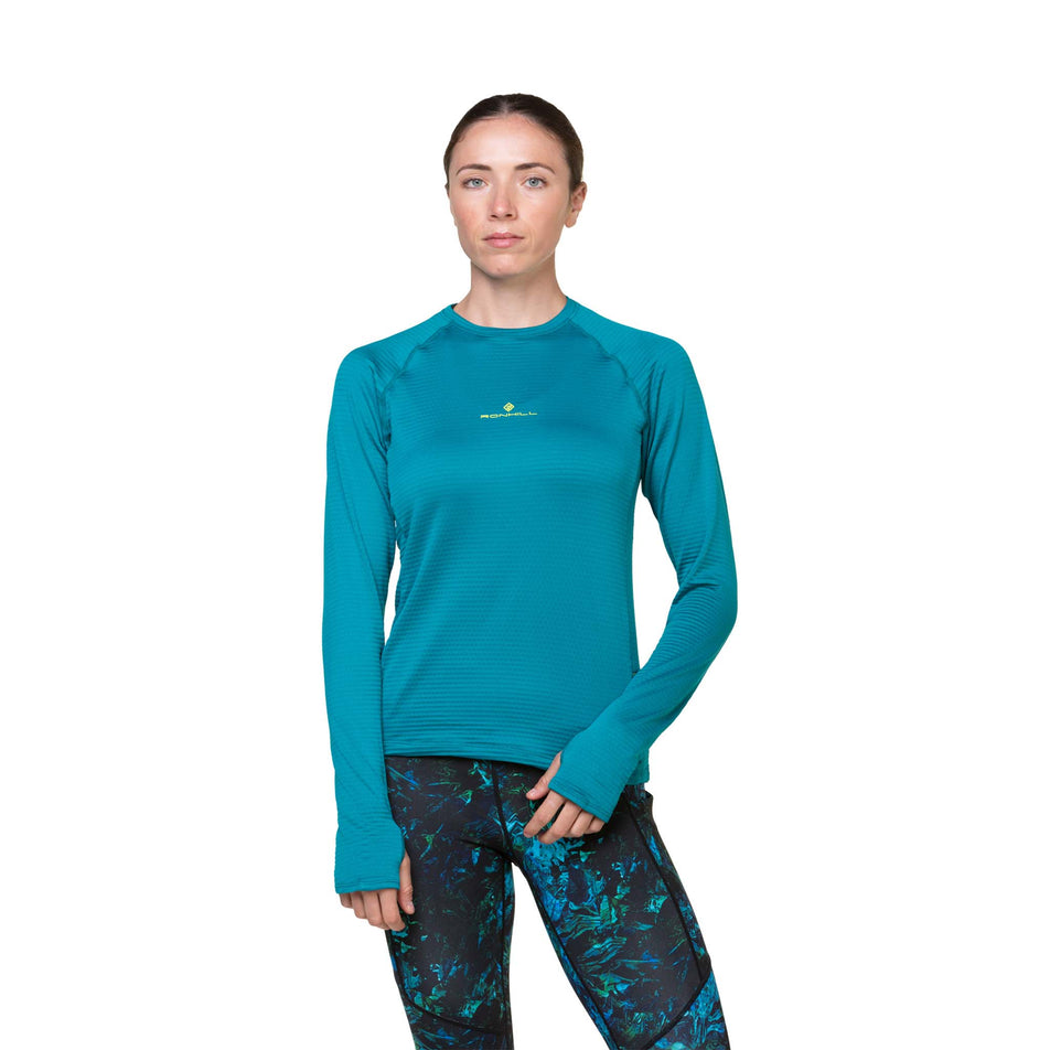 Front view of a model wearing a Ronhill Women's Tech Winter Crew in the Marine/Acid colourway. Model is also wearing leggings.  (8489875177634)