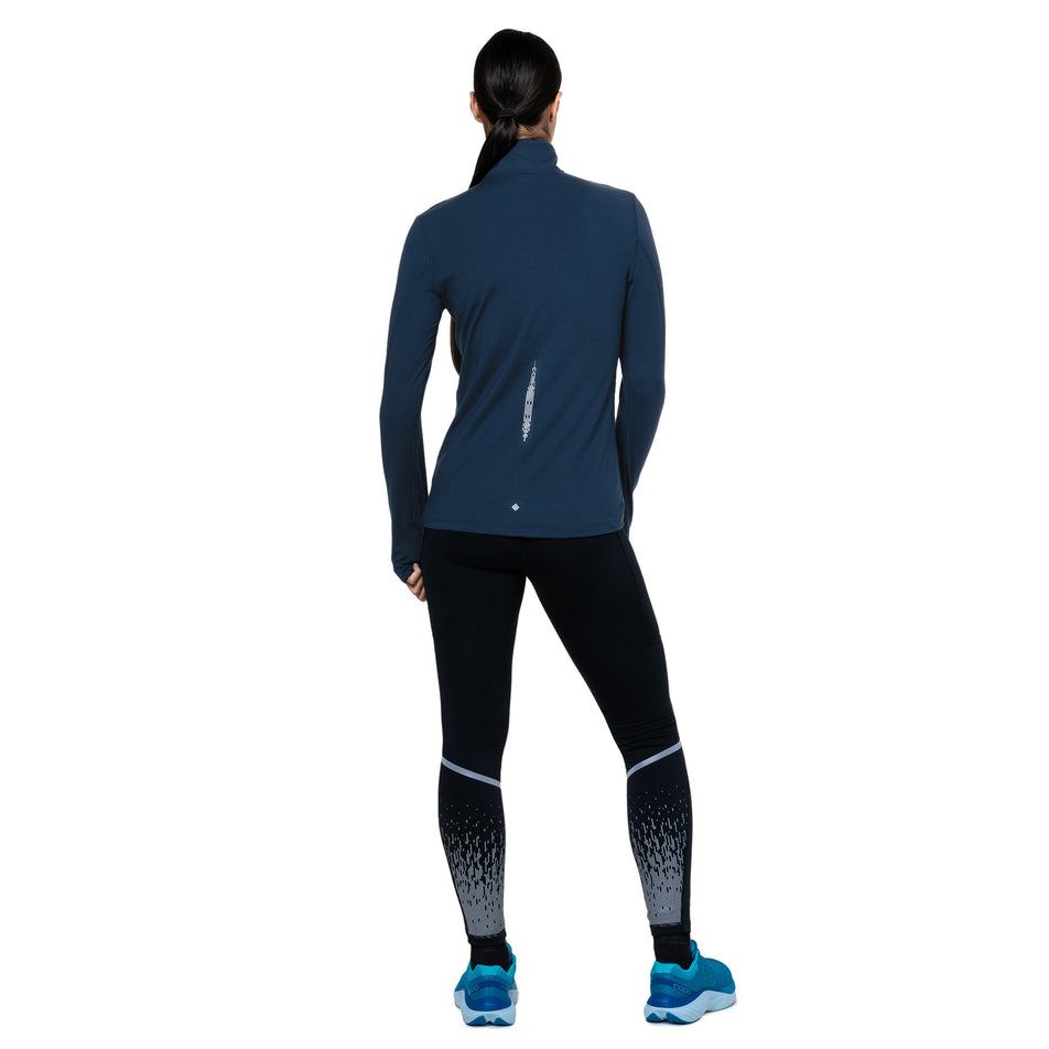 Back view of a model wearing the Ronhill Women's Tech Reflect 1/2 Zip in the Dark Navy/Reflect colourway. (8747154735266)