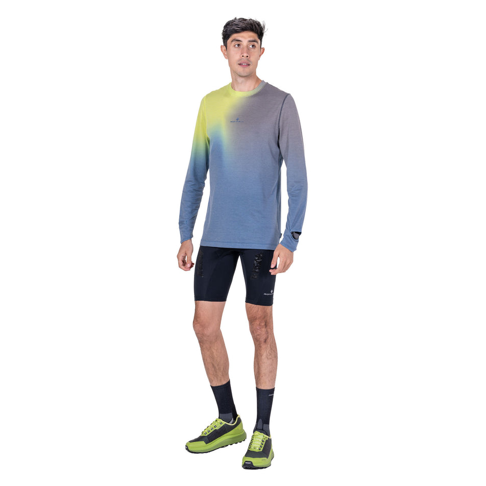 Front view of a model wearing the Ronhill Men's Tech Golden Hour L/S Tee in the Glacier Merge colourway.