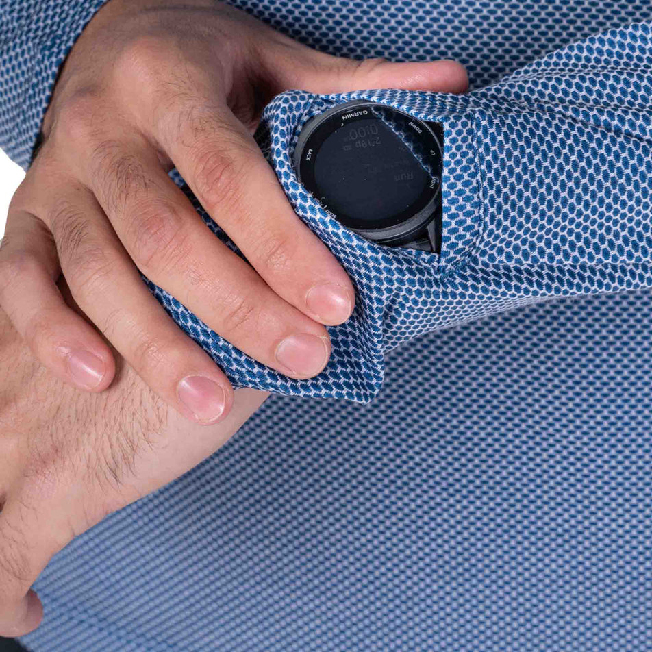 Close-up view of the watch window on the Ronhill Men's Tech Golden Hour L/S Tee in the Glacier Merge colourway.