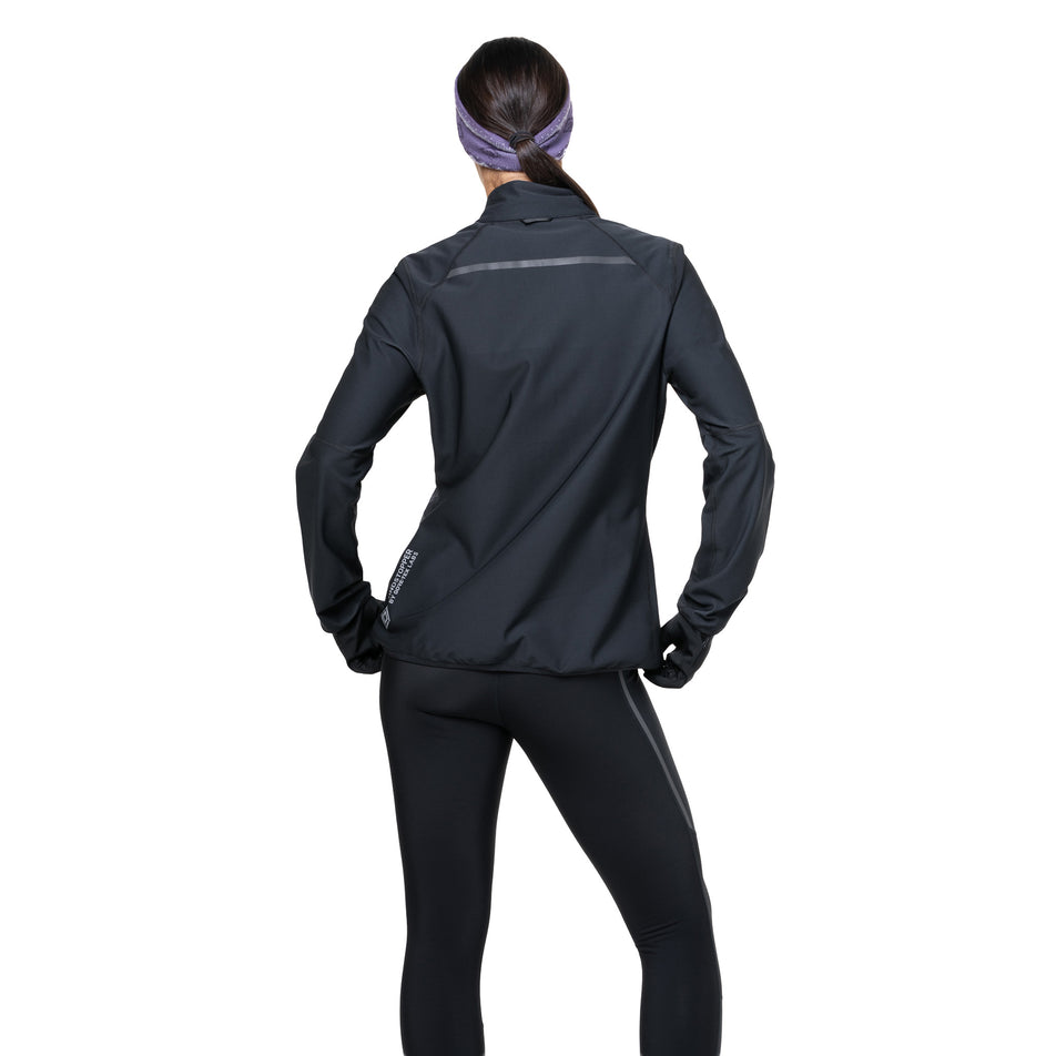 Back view of a model wearing the Ronhill Women's Tech GORE-TEX Windstopper Jacket in the All Black colourway. (8742206898338)