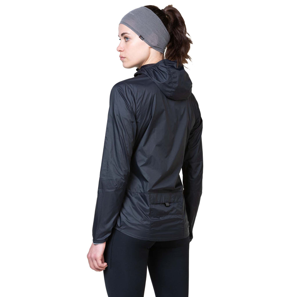 Back view of a model wearing the Ronhill Women's Tech All-Terrain Jacket in the All Black colourway. (8563593511074)