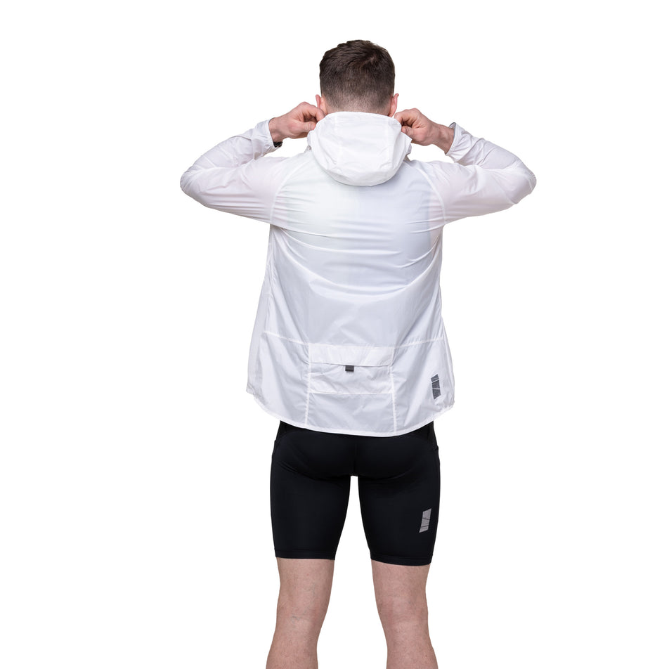Back view of a model wearing the Ronhill Men's Tech All-Terrain Jacket in the Bright White colourway. 