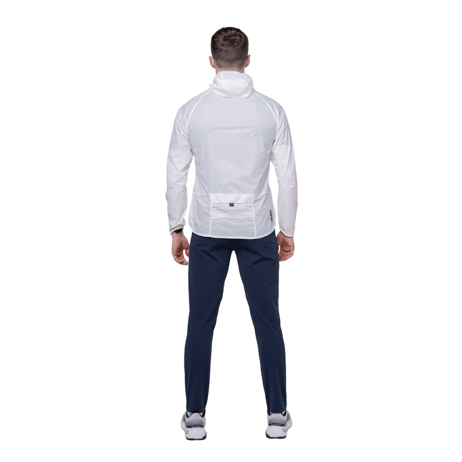 Back view of a model wearing the Ronhill Men's Tech All-Terrain Jacket in the Bright White colourway. 