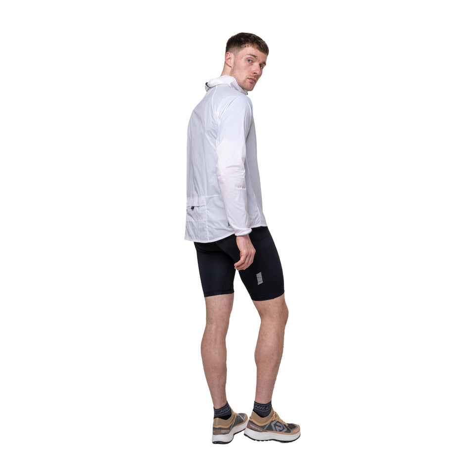 Angled view of a model wearing the Ronhill Men's Tech All-Terrain Jacket in the Bright White colourway. 