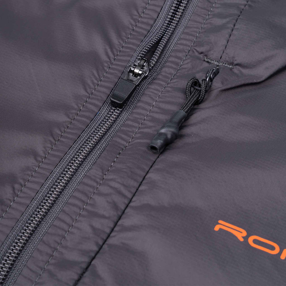 Close-up view of the front of the Ronhill Men's Tech All-Terrain Jacket in the Oxide/Ronhill Red colourway.